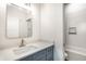 Bathroom vanity featuring white countertops, grey cabinets, and tile backsplash at 39 N Walcott St, Indianapolis, IN 46201