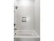 Bathroom shower and tub combination featuring white subway tile at 39 N Walcott St, Indianapolis, IN 46201