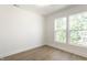 Bright bedroom featuring hardwood floors and natural light from two windows at 39 N Walcott St, Indianapolis, IN 46201