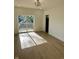 Bright bedroom featuring light wood floors, neutral walls, a modern light fixture, and sliding doors to an outdoor balcony at 39 N Walcott St, Indianapolis, IN 46201