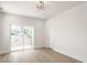 Bright bedroom with light hardwood floors, modern light fixture, and sliding glass door to balcony at 39 N Walcott St, Indianapolis, IN 46201