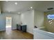 Upstairs bonus room with hardwood floors, a wet bar, and a doorway to an outdoor deck at 39 N Walcott St, Indianapolis, IN 46201