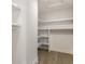 Walk-in closet with custom white shelving units and hardwood floors at 39 N Walcott St, Indianapolis, IN 46201