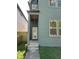 Modern home featuring a gray front door with windows and a covered porch with wood ceiling at 39 N Walcott St, Indianapolis, IN 46201