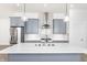 New kitchen with stainless steel appliances, gray cabinets, white backsplash, and light wood floors at 39 N Walcott St, Indianapolis, IN 46201
