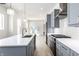New kitchen with stainless steel appliances, gray cabinets, white backsplash, and light wood floors at 39 N Walcott St, Indianapolis, IN 46201