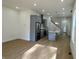 Open kitchen featuring gray cabinets, stainless steel appliances, hardwood floors, and a bright, spacious design at 39 N Walcott St, Indianapolis, IN 46201
