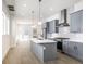 New kitchen with stainless steel appliances, gray cabinets, and light wood floors at 39 N Walcott St, Indianapolis, IN 46201