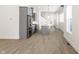 Open concept kitchen with stainless steel appliances and light hardwood floors at 39 N Walcott St, Indianapolis, IN 46201