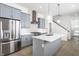 New kitchen with stainless steel appliances, gray cabinets, white backsplash, and light wood floors at 39 N Walcott St, Indianapolis, IN 46201