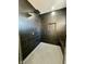 A modern black tiled shower features a rainfall shower head, handheld sprayer, a built-in niche, and a bench at 39 N Walcott St, Indianapolis, IN 46201