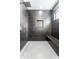 Modern black tiled shower with rainfall shower head, granite bench, and practical storage niche at 39 N Walcott St, Indianapolis, IN 46201