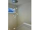 A stairway highlighted by a modern chandelier with a cluster of glass teardrop shaped lights hanging from a round, mirrored canopy at 39 N Walcott St, Indianapolis, IN 46201