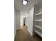 Spacious walk-in closet with wood floors, white walls and shelving, and modern lighting offering plenty of storage space at 39 N Walcott St, Indianapolis, IN 46201