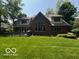 Large backyard with a deck, lush lawn, and brick home exterior at 4037 Oakleaf Dr, Zionsville, IN 46077