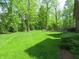Green backyard with trees surrounding the home at 4037 Oakleaf Dr, Zionsville, IN 46077