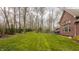 Expansive backyard featuring lush lawn, mature trees, and iron fence at 4037 Oakleaf Dr, Zionsville, IN 46077