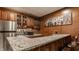 Finished basement bar with stainless steel refrigerator and granite counters at 4037 Oakleaf Dr, Zionsville, IN 46077