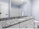 Bathroom featuring a granite countertop, white cabinets, and a large mirror at 4037 Oakleaf Dr, Zionsville, IN 46077