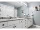 Bathroom featuring double sinks, granite counters, vanity, and decor at 4037 Oakleaf Dr, Zionsville, IN 46077