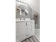 Bathroom with round mirror, white vanity, and a shower in the background at 4037 Oakleaf Dr, Zionsville, IN 46077