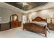 Serene bedroom with a wood bed frame, detailed ceiling, and neutral color scheme at 4037 Oakleaf Dr, Zionsville, IN 46077