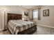 Cozy bedroom with a comfortable queen bed, a window seat, and a traditional lamp at 4037 Oakleaf Dr, Zionsville, IN 46077
