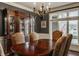 Elegant dining room with a wooden table, patterned chairs, and a large window for natural lighting at 4037 Oakleaf Dr, Zionsville, IN 46077