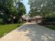 Charming brick home with a long driveway and mature trees at 4037 Oakleaf Dr, Zionsville, IN 46077