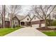 Beautiful brick home with a manicured lawn, mature trees, and a spacious driveway at 4037 Oakleaf Dr, Zionsville, IN 46077
