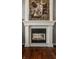 Elegant fireplace with white mantle, tapestry, and dark hardwood floors at 4037 Oakleaf Dr, Zionsville, IN 46077