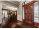 Inviting foyer with hardwood floors, a decorative front door, and views into the dining room at 4037 Oakleaf Dr, Zionsville, IN 46077