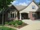 Beautiful brick home featuring a manicured front lawn, blooming flowers, and stone accents at 4037 Oakleaf Dr, Zionsville, IN 46077