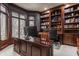 Spacious home office with custom built-in shelving, desk, and a large window for natural light at 4037 Oakleaf Dr, Zionsville, IN 46077