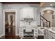 Kitchen with a built-in desk space with a granite countertop and white cabinets at 4037 Oakleaf Dr, Zionsville, IN 46077