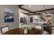 Bright kitchen featuring stainless steel appliances, granite countertops, and rich wood beams at 4037 Oakleaf Dr, Zionsville, IN 46077
