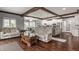 Open-concept living area with hardwood floors, a fireplace, and an adjacent kitchen at 4037 Oakleaf Dr, Zionsville, IN 46077