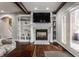 Living room showcasing a fireplace, built-in shelving, and access to an outdoor space at 4037 Oakleaf Dr, Zionsville, IN 46077