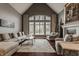 Spacious living room with a large window offering scenic backyard views and vaulted ceiling at 4037 Oakleaf Dr, Zionsville, IN 46077