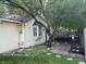 Backyard patio with an outdoor dining area, grill, and well-maintained landscaping at 404 Pearl St, Pendleton, IN 46064
