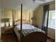 Cozy bedroom with a four-poster bed and ample natural light from the window at 404 Pearl St, Pendleton, IN 46064