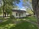Charming home with mature trees providing shade and a welcoming curb appeal on a sunny day at 404 Pearl St, Pendleton, IN 46064
