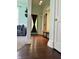 Inviting hallway featuring hardwood floors and decorative trim, seamlessly connecting living spaces at 404 Pearl St, Pendleton, IN 46064