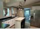 Charming kitchen with white cabinets, stainless steel appliances, and a butcher block island at 404 Pearl St, Pendleton, IN 46064