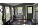 Bright sunroom with large windows, a cozy atmosphere and a dark wood floor at 404 Pearl St, Pendleton, IN 46064