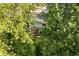 Aerial view of a house with a deck surrounded by lush green trees, offering privacy and a serene outdoor space at 410 Wood Hollow Ct, Westfield, IN 46074