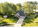 Aerial view of a charming home with lush landscaping, mature trees, and a well-manicured lawn at 410 Wood Hollow Ct, Westfield, IN 46074