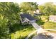 Aerial view of a house surrounded by green trees and a green lawn and driveway at 410 Wood Hollow Ct, Westfield, IN 46074