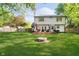 Large backyard with a fire pit, deck with grill, and plenty of space for outdoor activities at 410 Wood Hollow Ct, Westfield, IN 46074