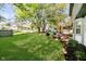 Spacious backyard featuring mature trees, lush lawn, grill, and outdoor seating area at 410 Wood Hollow Ct, Westfield, IN 46074